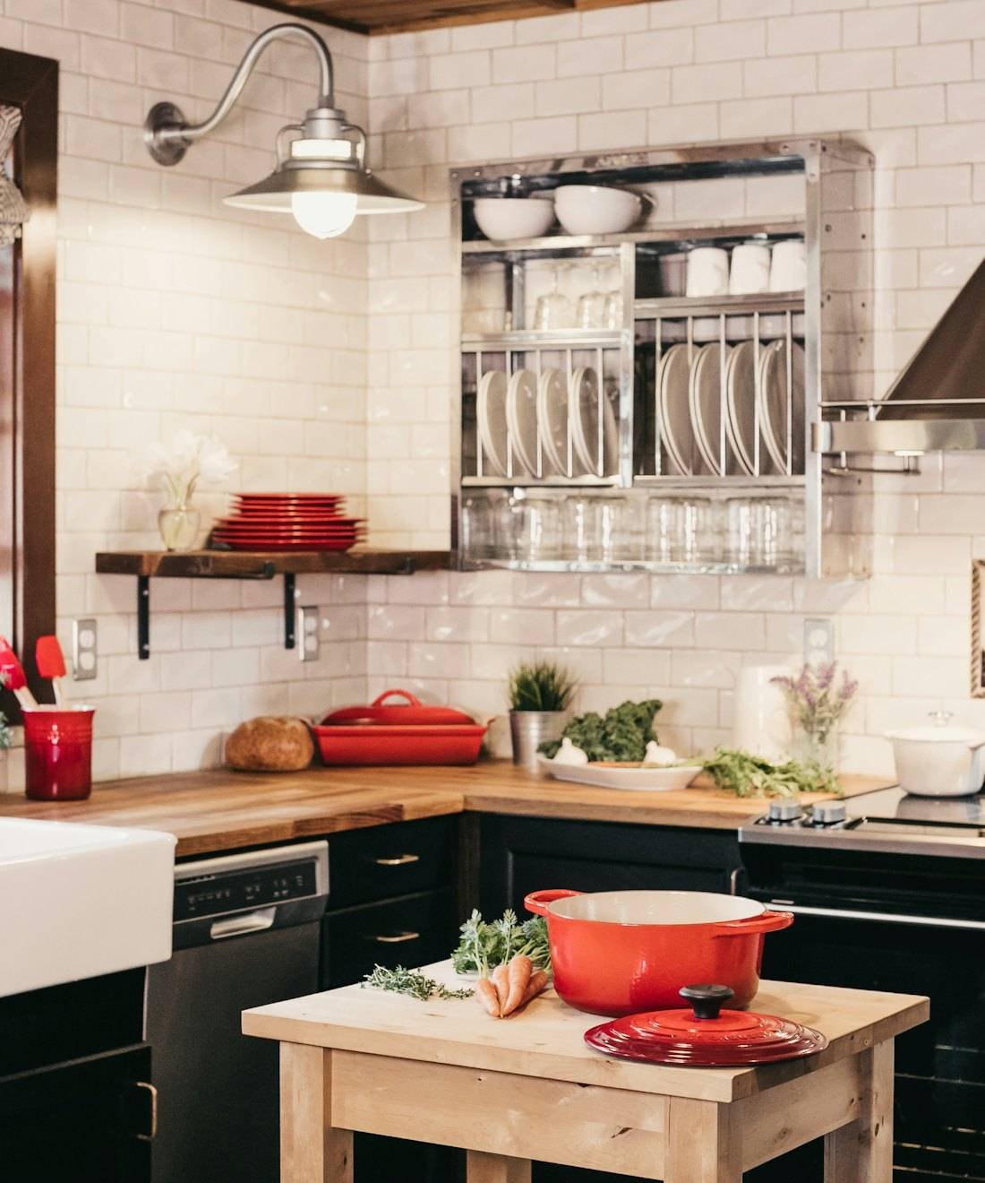 A bright kitchen with white tiles and a central worktop